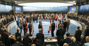 leaders-watch-their-flags-they-participate-nato-summit-session-one